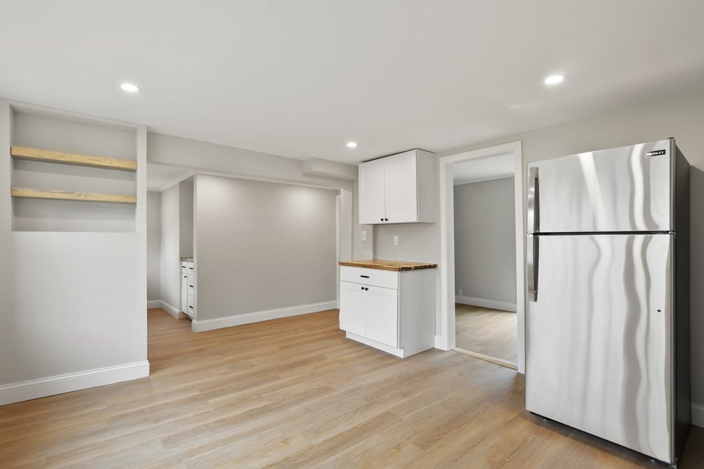 90 Manning Street Hudson, MA 01749 - Photo 8 of 33 a kitchen with a refrigerator and a sink