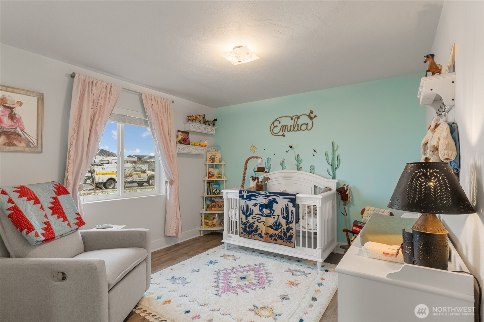 928 Q Street Southwest Quincy, WA 98848 - Photo 12 of 26 a living room with furniture and a baby crib