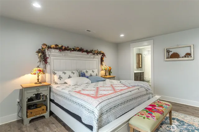 a bedroom with a bed and a lamp on table