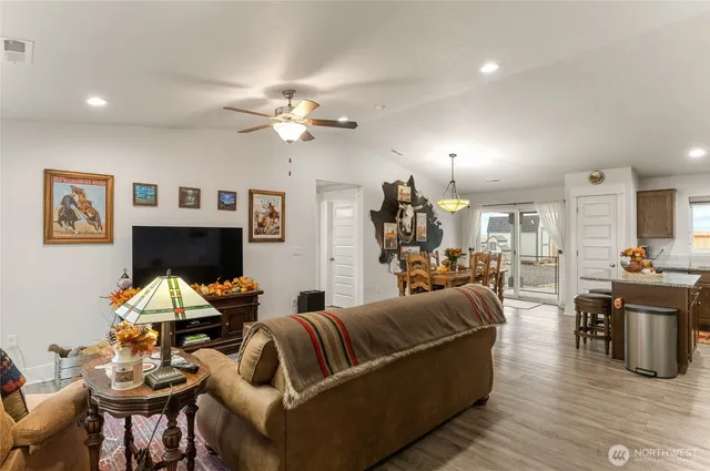 a living room with furniture a fireplace and wooden floor