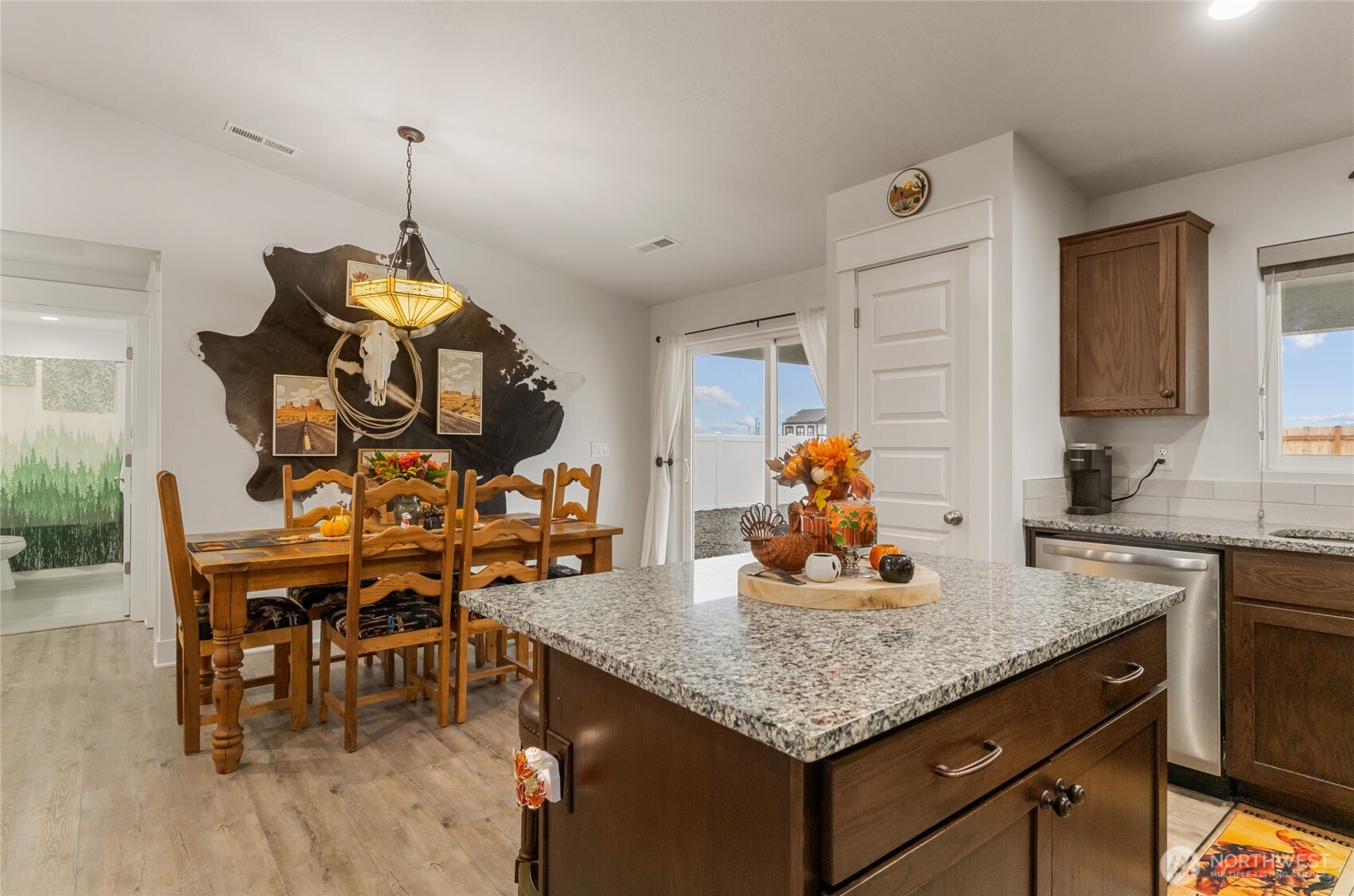 928 Q Street Southwest Quincy, WA 98848 - Photo 8 of 26 a kitchen with stainless steel appliances granite countertop a table and chairs in it