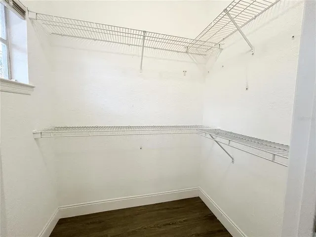 a spacious bathroom with a granite countertop toilet a sink and a mirror