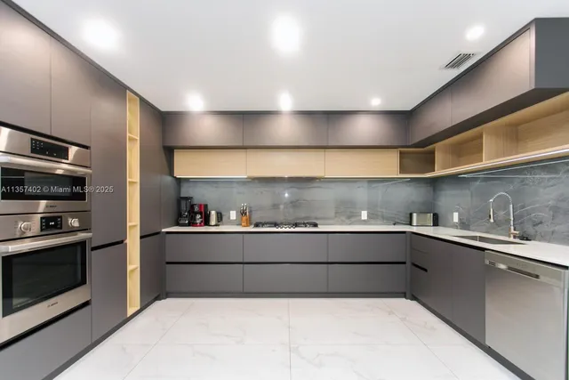 a kitchen with stainless steel appliances and a refrigerator