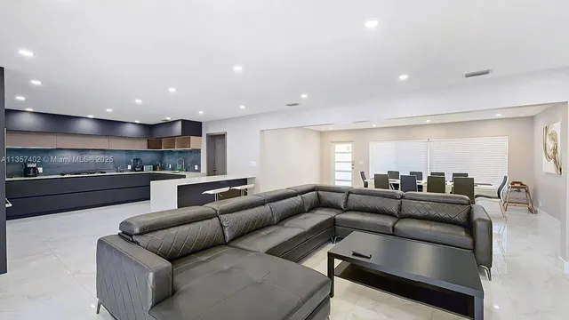 a living room with furniture and kitchen view