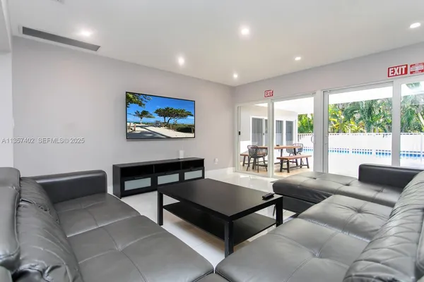a living room with furniture a rug and a large window