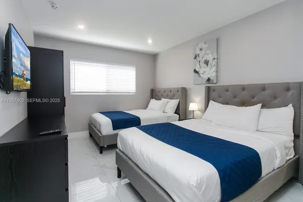 a bedroom with a large bed and a large window