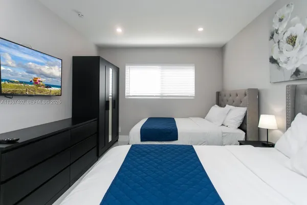 a bedroom with a bed and a flat screen tv