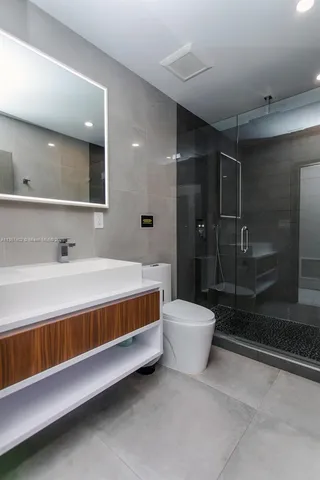 a bathroom with a sink toilet and shower