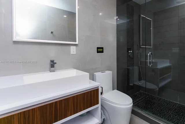 a bedroom with bed and paintings on the wall