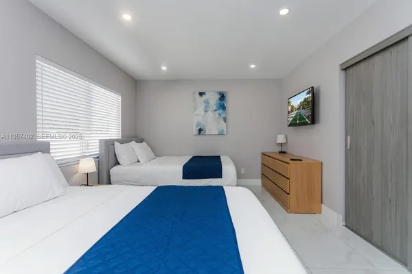 a view of a bedroom with washer and dryer