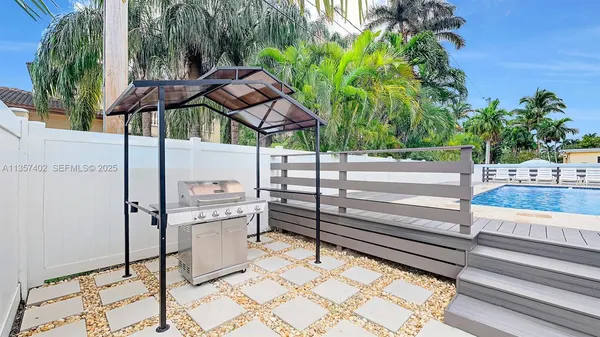 a view of backyard with sitting area