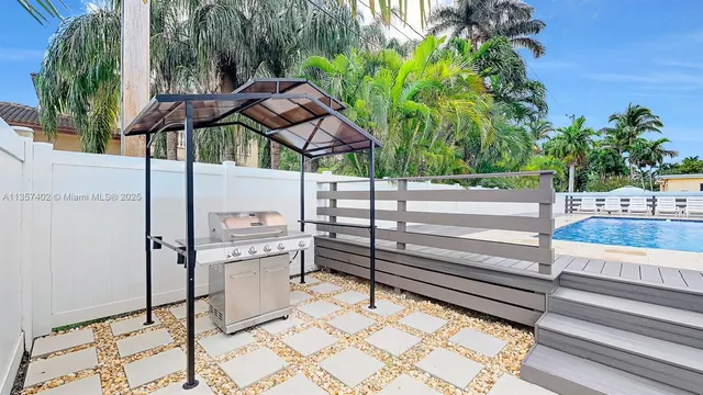 a view of backyard with sitting area