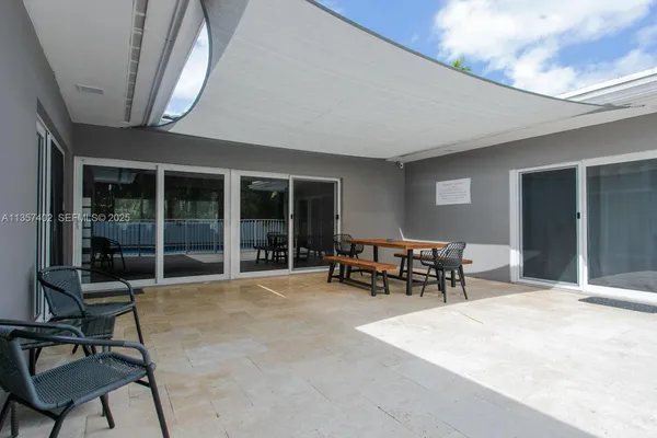 a view of a entryway with a table and chairs
