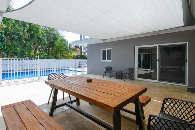 a view of a dinning table and chairs in patio