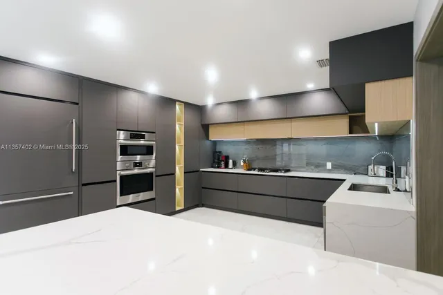 a kitchen with a stove sink and refrigerator
