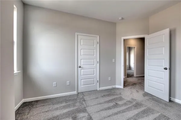 an empty room with closet and mirror
