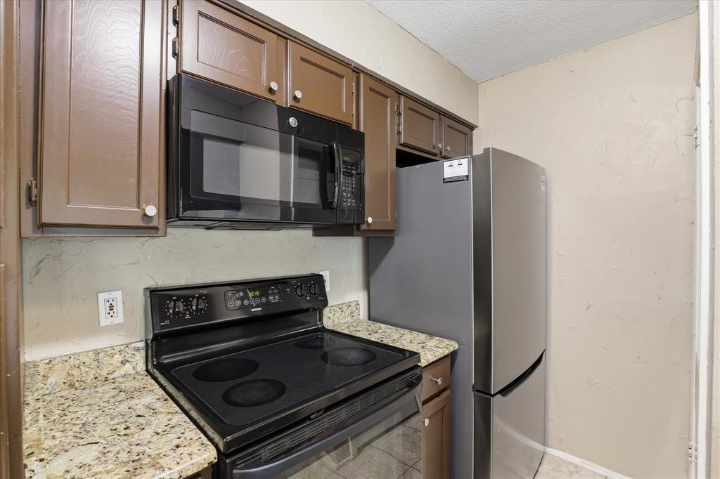 5616 Preston Oaks Road, Unit 404 Dallas, TX 75254 - Photo 16 of 34 Refrigerator comes with the condo.