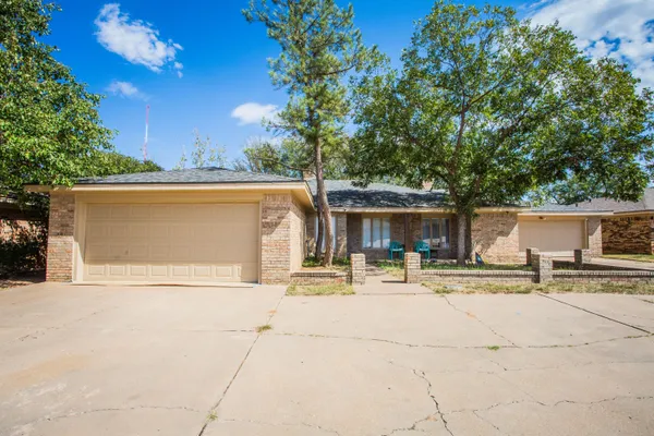 a front view of a house with basket ball court and outdoor seating