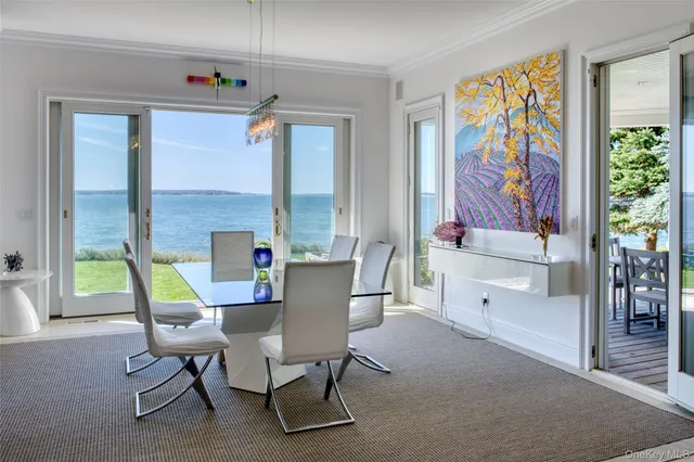 a view of a dining room with furniture a chandelier and wooden floor
