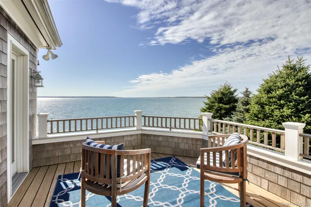 a view of a roof deck with wooden fence and floor