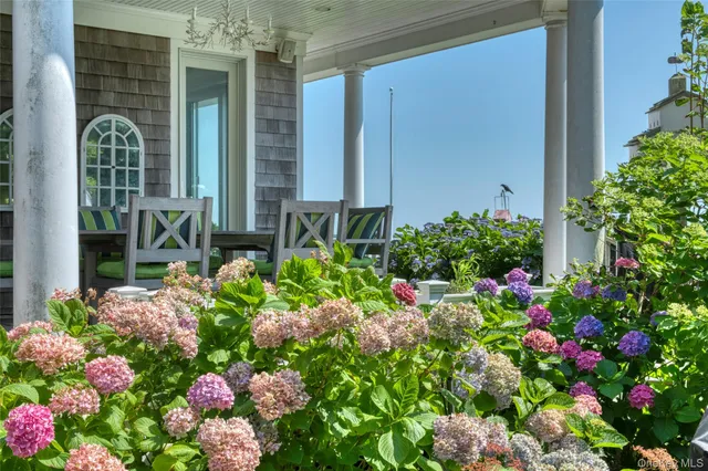 a bunch of flowers are in front of a house