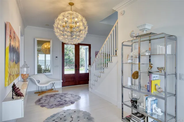 a living room with furniture and a chandelier