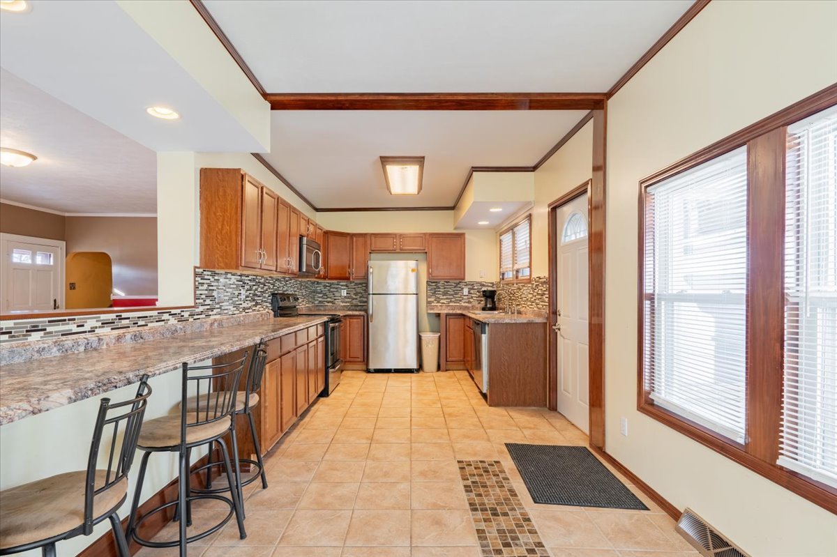 603 South Main Street Eureka, IL 61530 - Photo 11 of 32 a kitchen with a stove a refrigerator and a sink