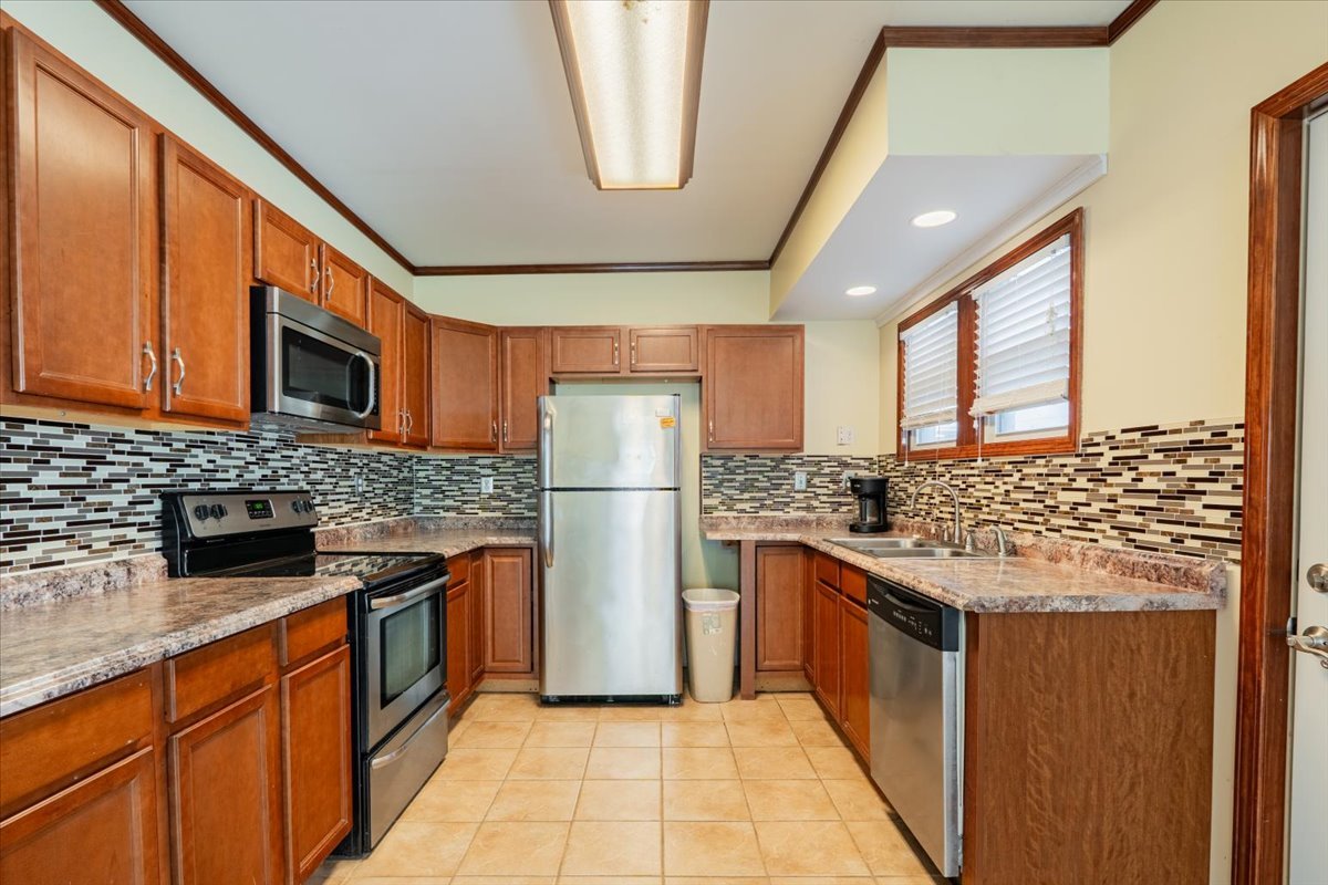 603 South Main Street Eureka, IL 61530 - Photo 13 of 32 a kitchen with stainless steel appliances granite countertop a refrigerator and a stove top oven