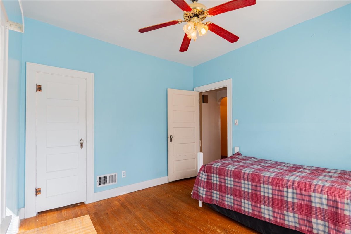 603 South Main Street Eureka, IL 61530 - Photo 16 of 32 a bedroom with a bed and a chandelier
