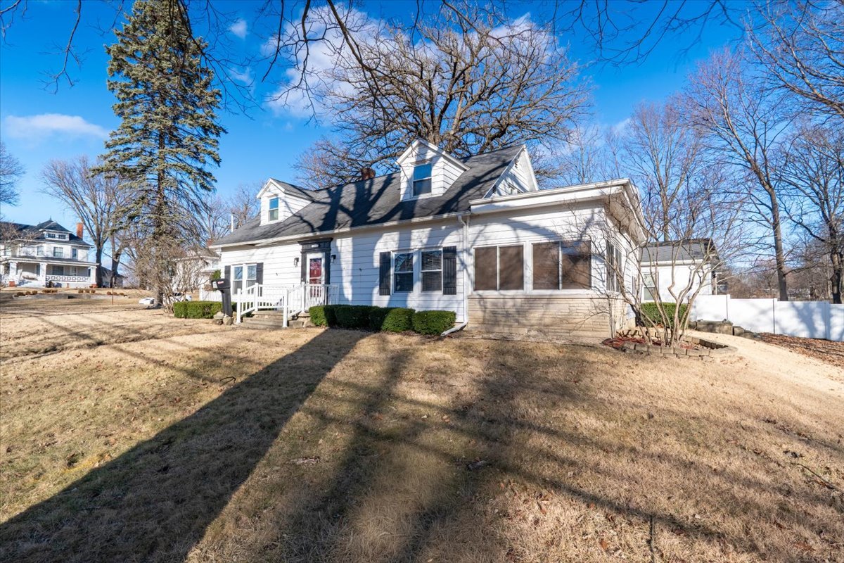 603 South Main Street Eureka, IL 61530 - Photo 2 of 32 a view of a white house with a yard covered with snow