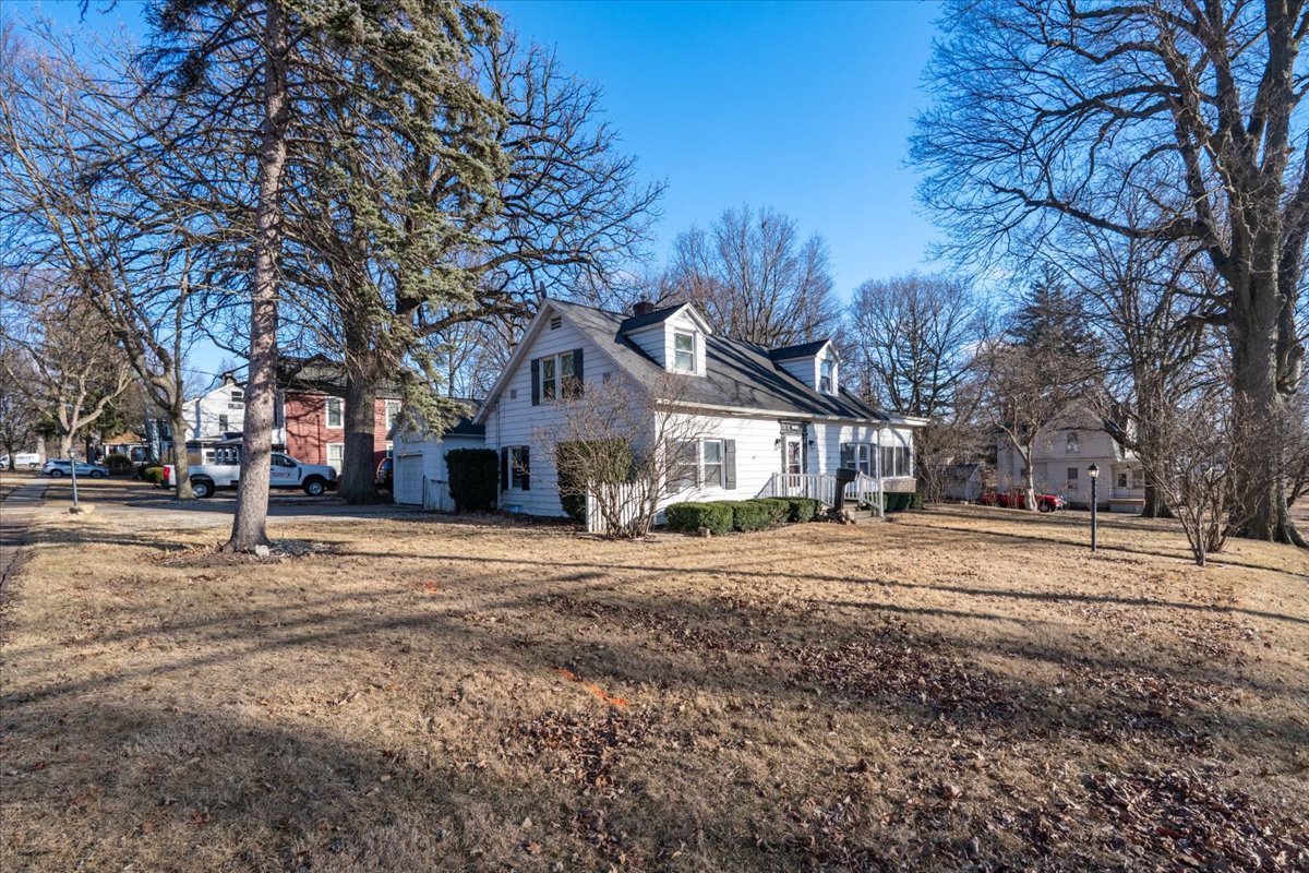 603 South Main Street Eureka, IL 61530 - Photo 3 of 32 a front view of a house with a yard and large trees