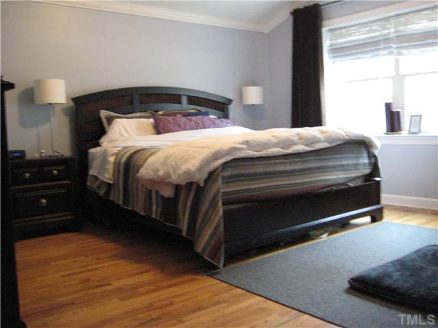 1700 Su John Road Raleigh, NC 27607 - Photo 12 of 18 a bedroom with a bed and a lamp