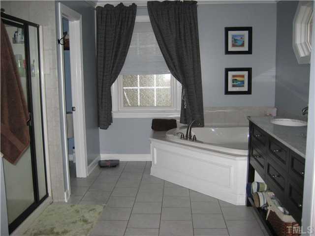 1700 Su John Road Raleigh, NC 27607 - Photo 13 of 18 a bathroom with a bathtub sink and mirror