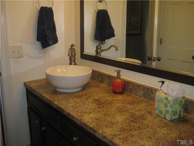 1700 Su John Road Raleigh, NC 27607 - Photo 14 of 18 a bathroom with a sink and a mirror