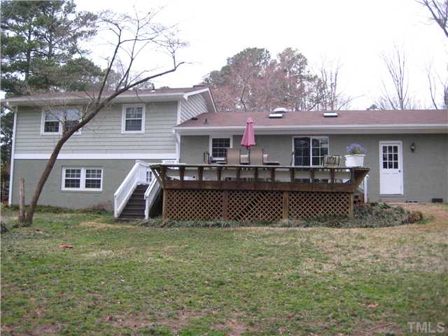 1700 Su John Road Raleigh, NC 27607 - Photo 15 of 18 a view of a house with a bed and a yard