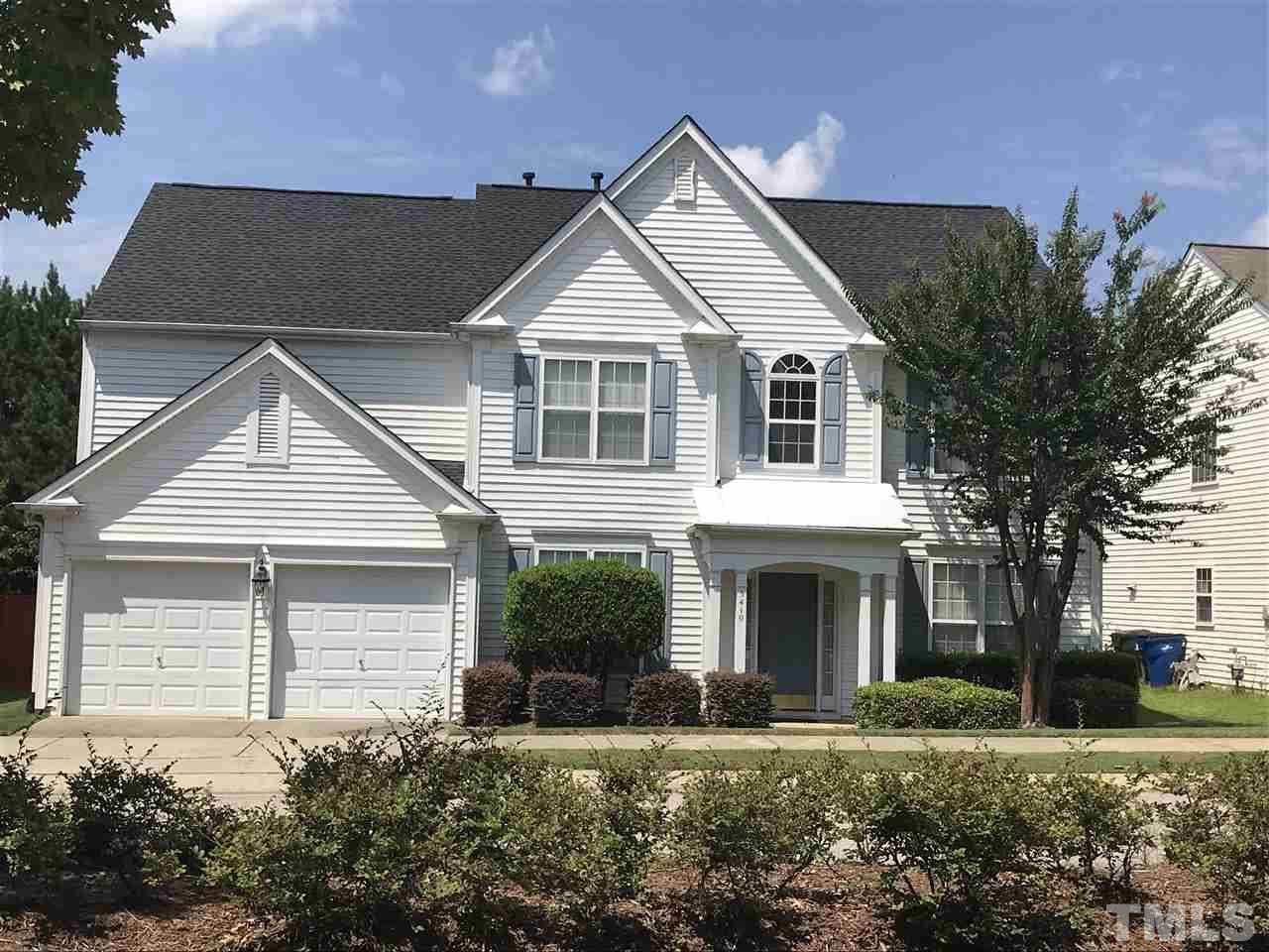 5410 Wind Mountain Lane Raleigh, NC 27613 - Photo 1 of 13 a front view of a house with a yard and garage