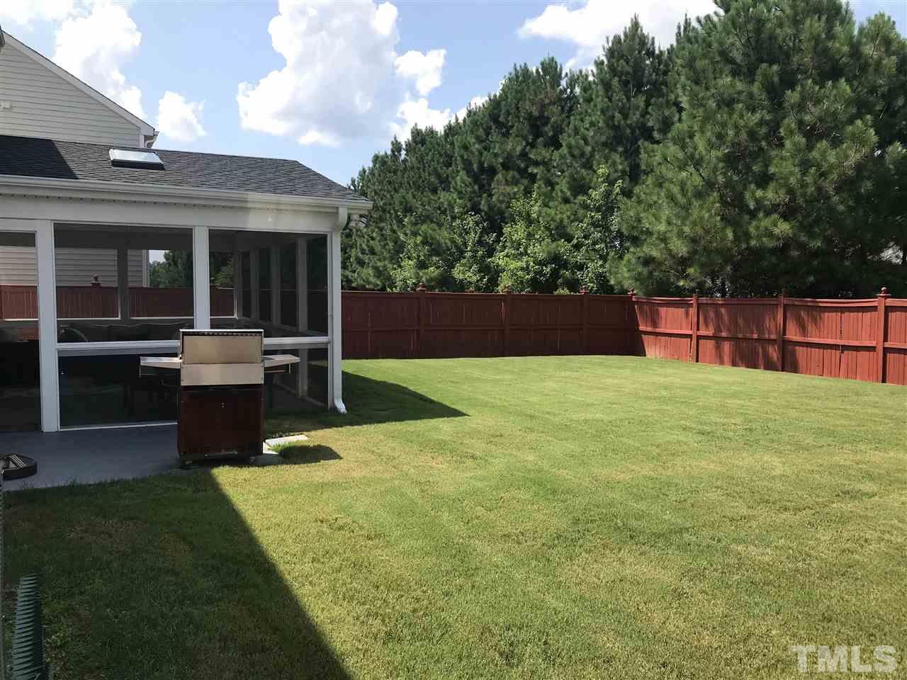 5410 Wind Mountain Lane Raleigh, NC 27613 - Photo 3 of 13 a view of a backyard with table and chairs with wooden fence