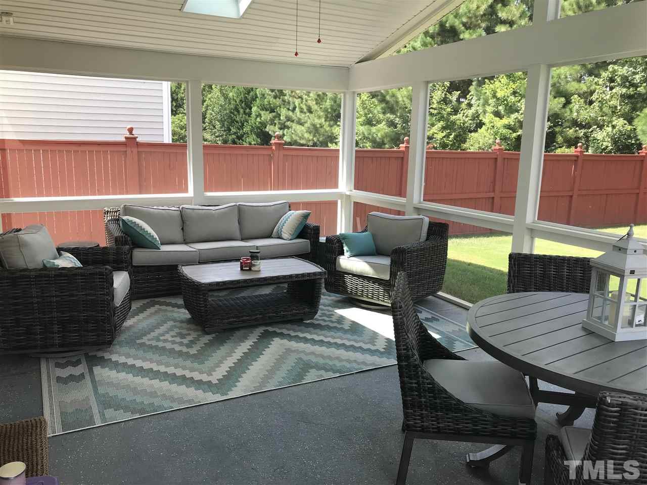 5410 Wind Mountain Lane Raleigh, NC 27613 - Photo 5 of 13 a living room with patio furniture and a potted plant