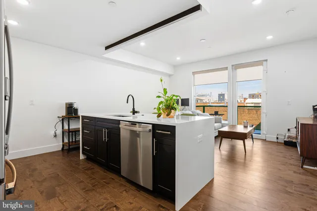 a view of kitchen with cabinets and wooden floor
