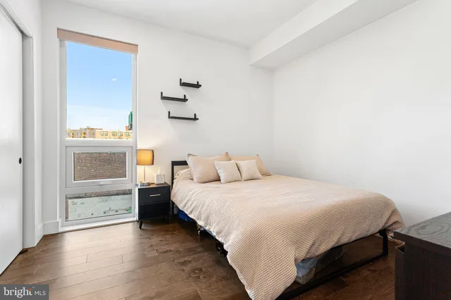 a bedroom with a bed and a window