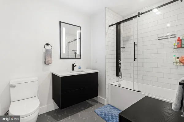 a bathroom with a sink toilet and shower