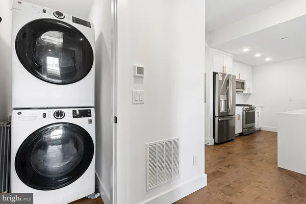 a view of a hallway with washer and dryer