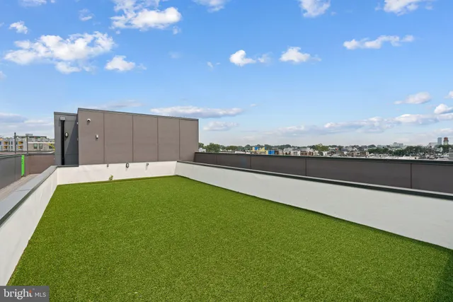 a kitchen with stainless steel appliances kitchen island granite countertop a large counter top a stove and a wooden floors