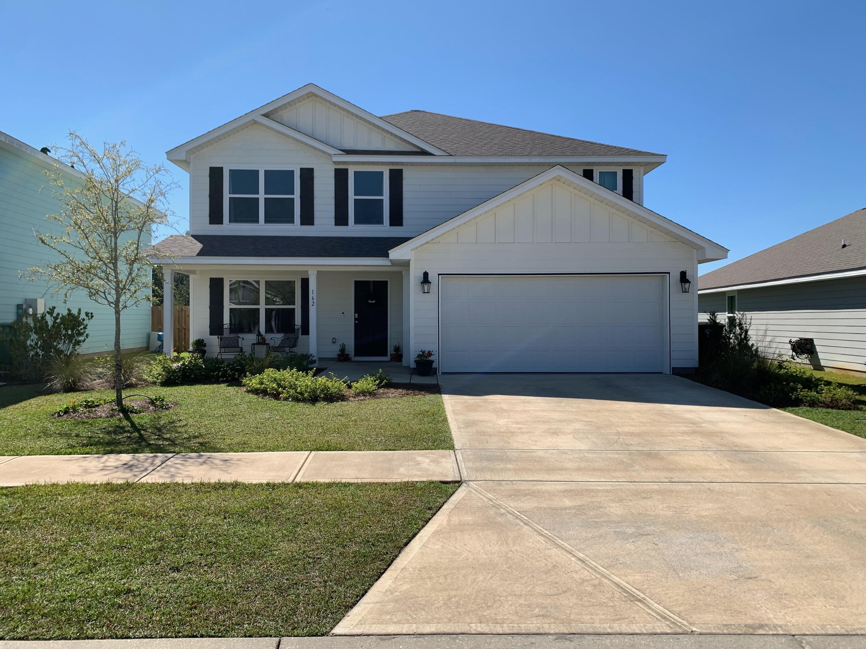 162 This Way Freeport, FL 32439 - Photo 1 of 55 a front view of a house with a yard and garage