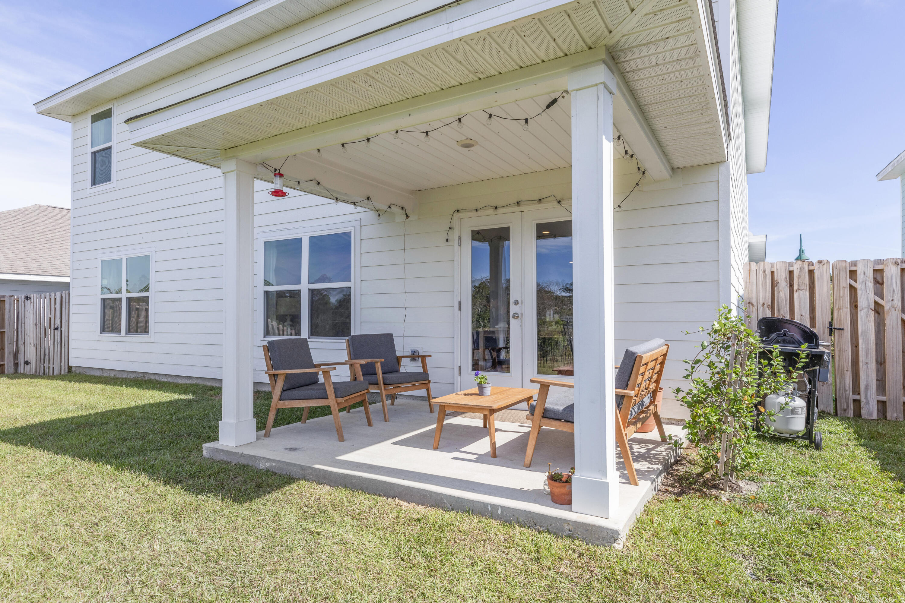 162 This Way Freeport, FL 32439 - Photo 54 of 55 a view of a patio with table and chairs potted plants and floor to ceiling window