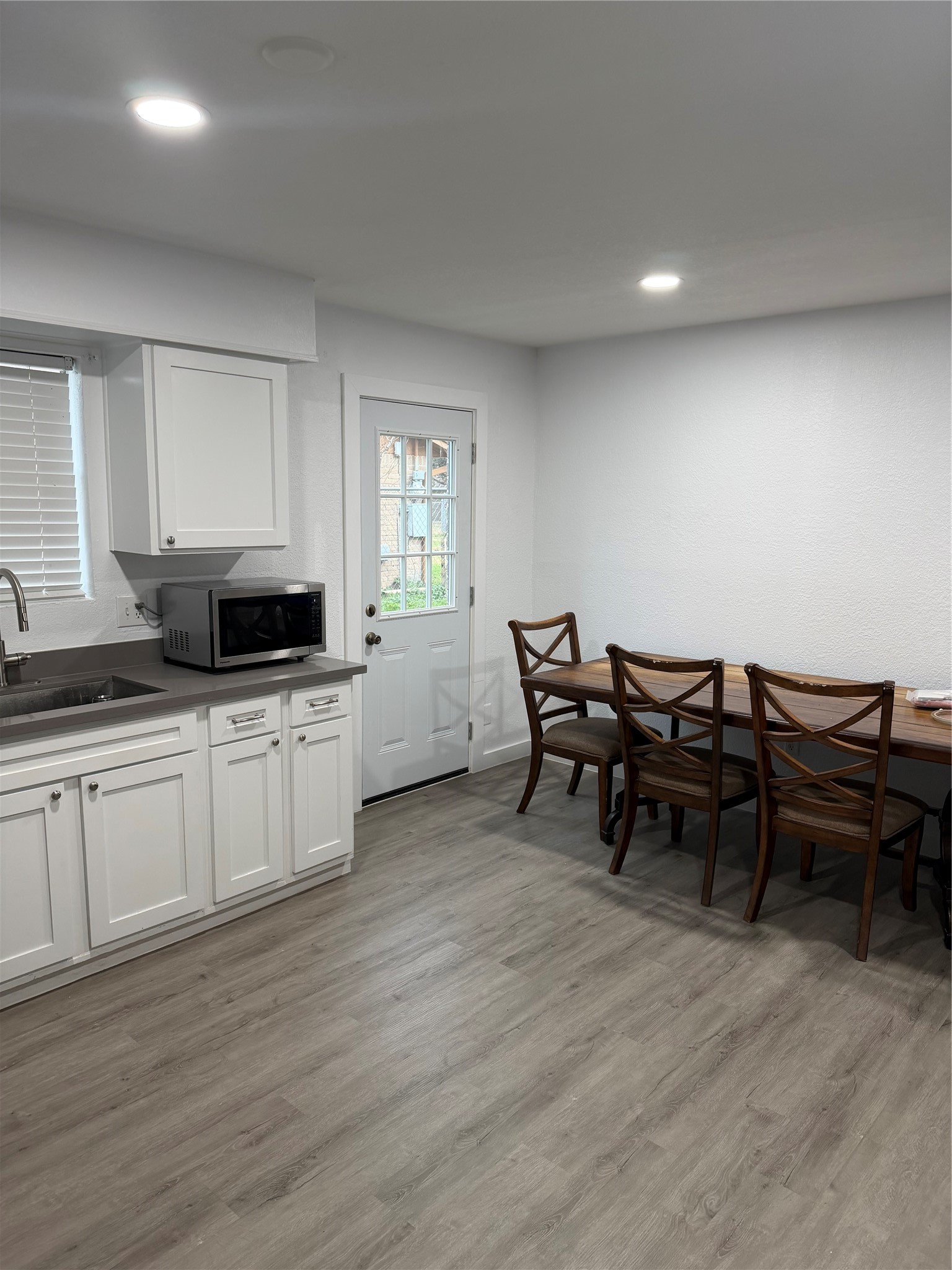229 Austin Street Angleton, TX 77515 - Photo 11 of 36 a kitchen with a table and chairs in it