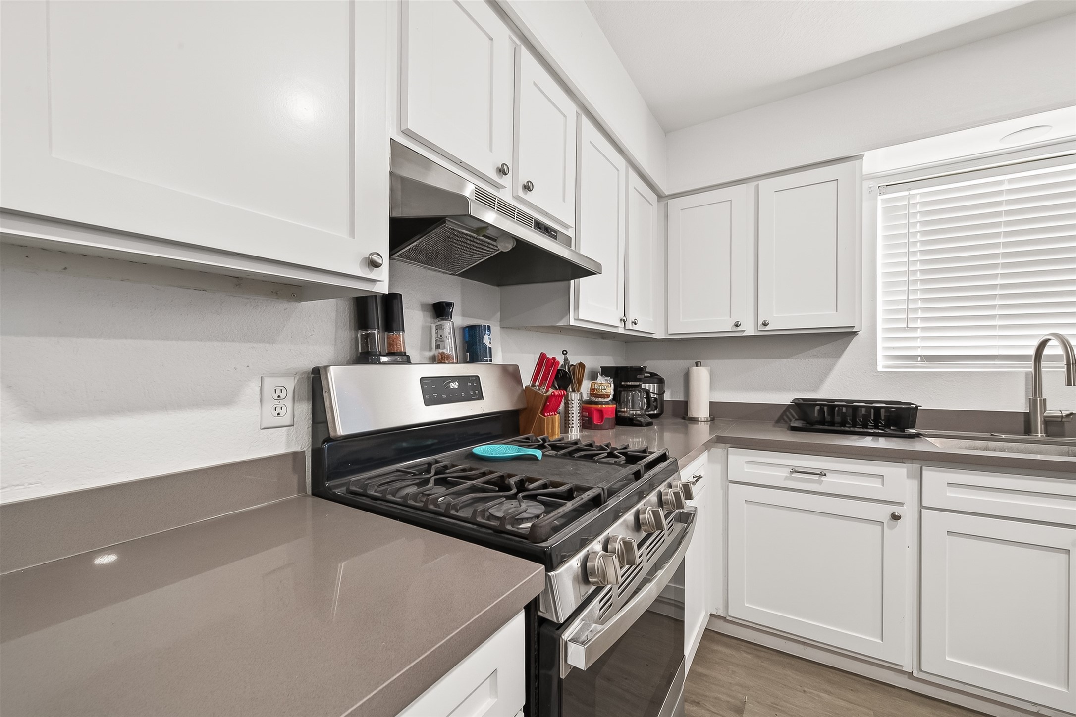 229 Austin Street Angleton, TX 77515 - Photo 15 of 36 a kitchen with stainless steel appliances granite countertop a sink stove and cabinets