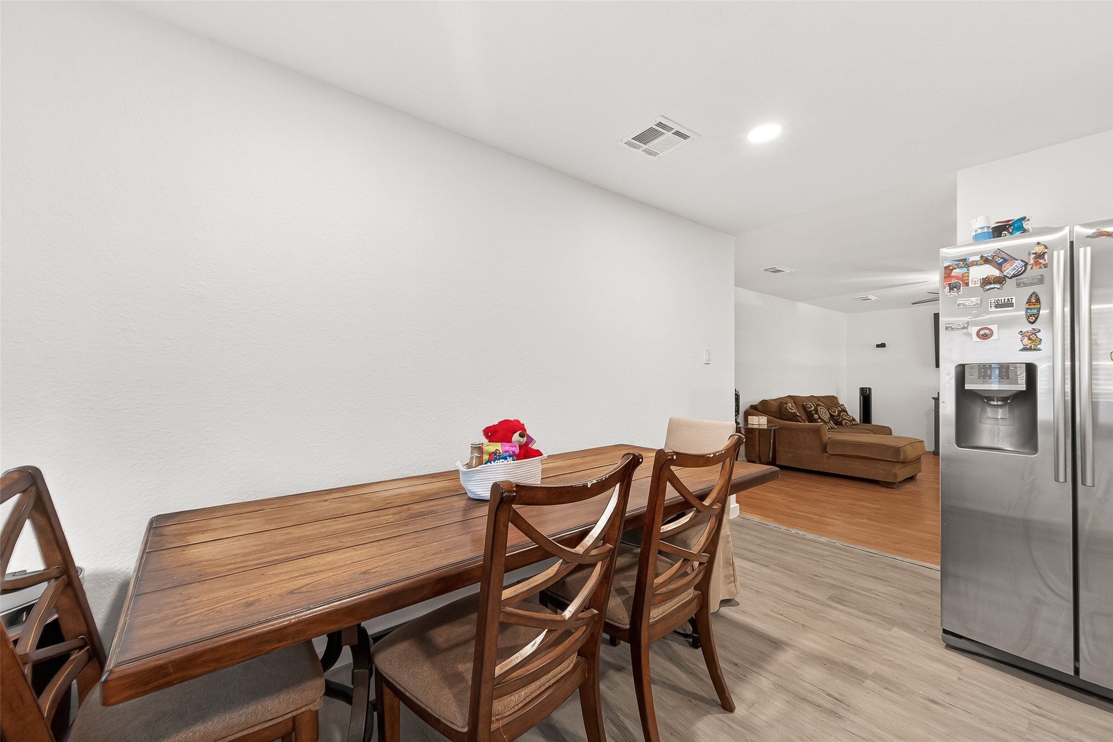229 Austin Street Angleton, TX 77515 - Photo 18 of 36 a view of a dining room with furniture and wooden floor