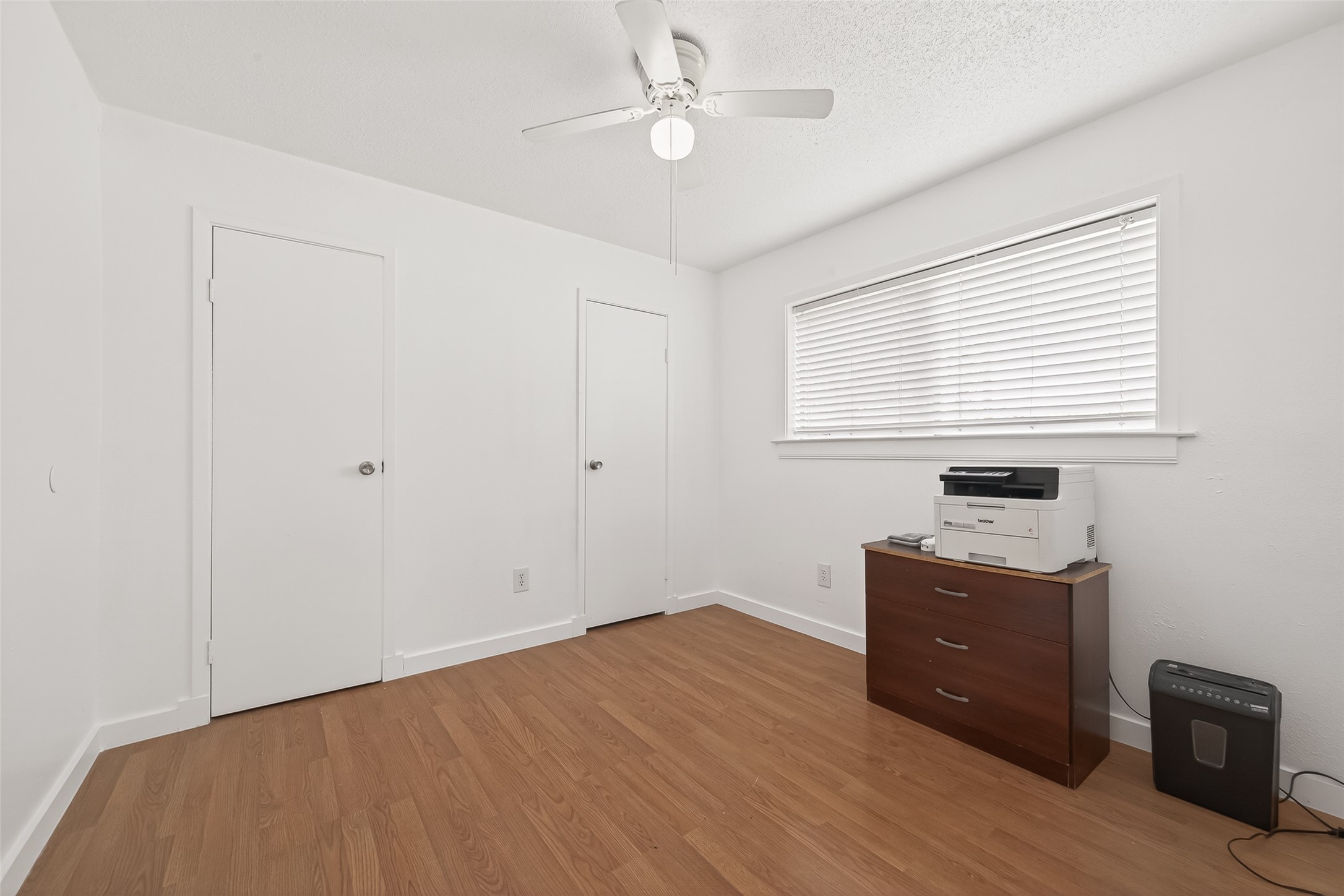 229 Austin Street Angleton, TX 77515 - Photo 21 of 36 a workspace with wooden floor