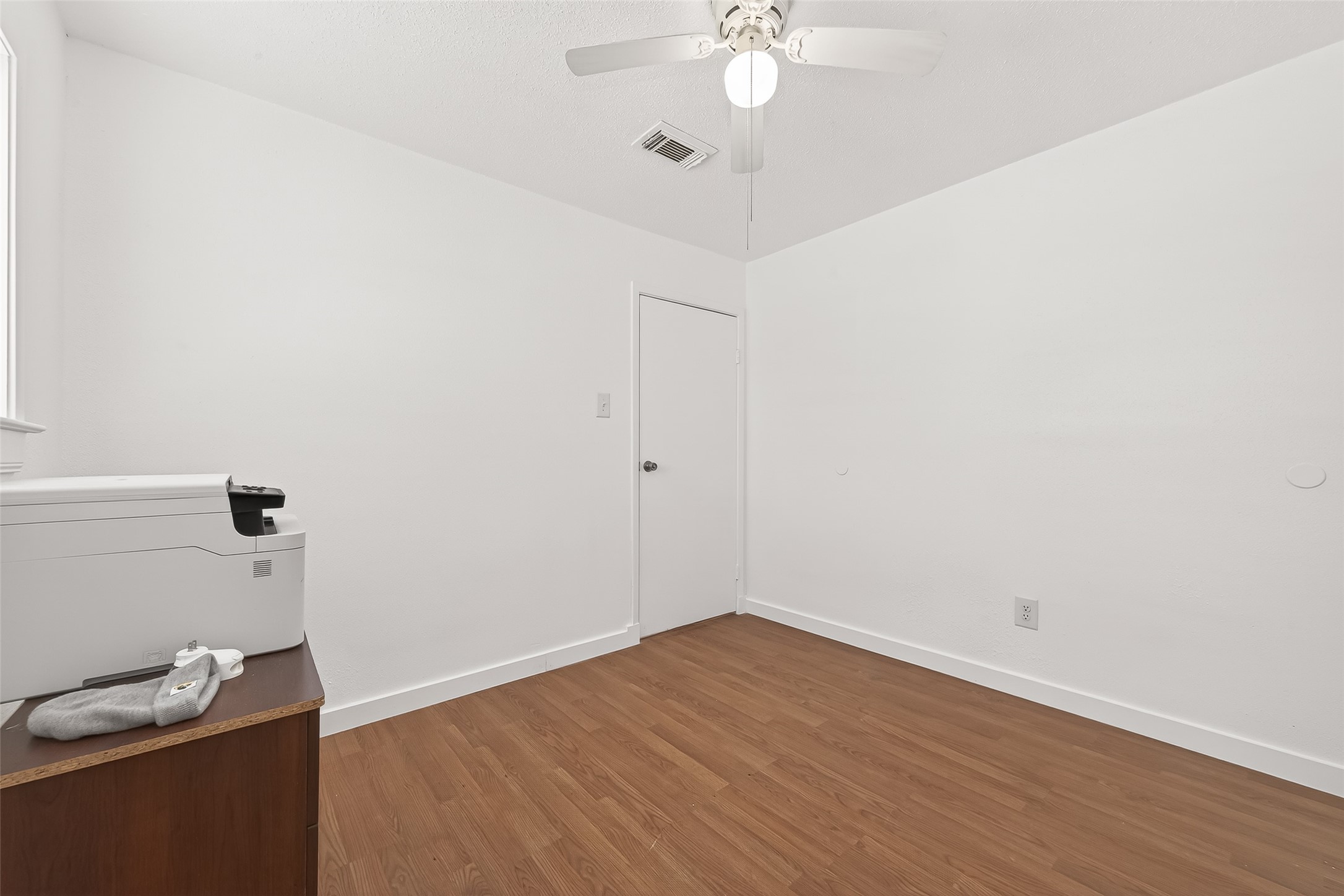 229 Austin Street Angleton, TX 77515 - Photo 22 of 36 wooden floor in an empty room